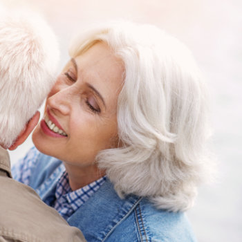 Affectionate embrace between an elderly couple.